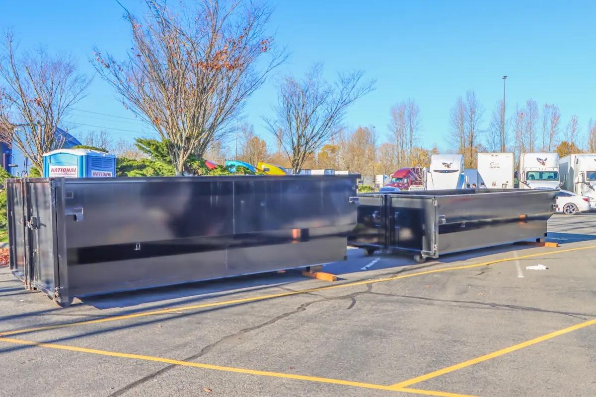 Professional dumpster rental service with roll-off container on residential driveway in Yankee Springs